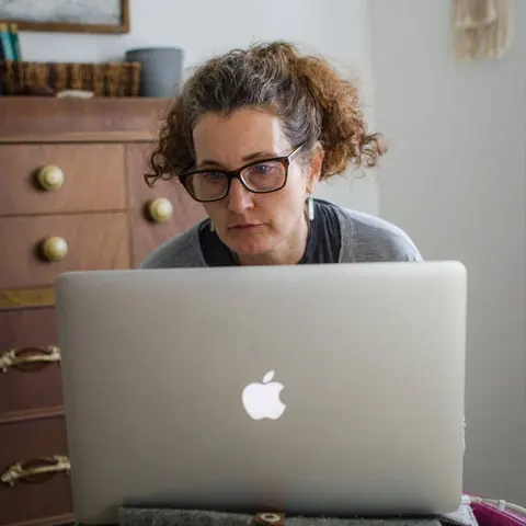 Patricia Neumann writing at her laptop